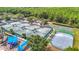 An aerial view of tennis and basketball courts surrounded by lush greenery at 4207 Fishermans Lake Dr, Lutz, FL 33558