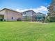 Large backyard with screened in patio and plenty of green grass at 4207 Fishermans Lake Dr, Lutz, FL 33558