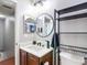 Bright bathroom featuring a round mirror, decorative shower curtain, and dark wood vanity at 4207 Fishermans Lake Dr, Lutz, FL 33558