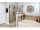 A glass shower, soaking tub, and decorative wall art adorn the bathroom at 4207 Fishermans Lake Dr, Lutz, FL 33558