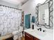 Updated bathroom with a modern vanity, mirror, and a unique shower curtain at 4207 Fishermans Lake Dr, Lutz, FL 33558