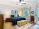 Bright main bedroom featuring a blue quilt and a side table with lamps at 4207 Fishermans Lake Dr, Lutz, FL 33558
