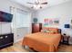 This bedroom features a ceiling fan, bed, dresser, and side table at 4207 Fishermans Lake Dr, Lutz, FL 33558