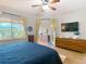 Well-lit main bedroom featuring a blue quilt and a patio walkthrough at 4207 Fishermans Lake Dr, Lutz, FL 33558