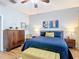 Bright main bedroom featuring a blue quilt, side tables with lamps, and lots of natural light at 4207 Fishermans Lake Dr, Lutz, FL 33558