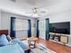 Bedroom with modern decor, ceiling fan, wood-style flooring and natural lighting at 4207 Fishermans Lake Dr, Lutz, FL 33558