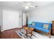 Bedroom with modern gray decor, closet, and light wood-style flooring at 4207 Fishermans Lake Dr, Lutz, FL 33558