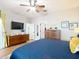 Bright main bedroom featuring a blue quilt and lots of natural light at 4207 Fishermans Lake Dr, Lutz, FL 33558