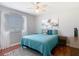 Bedroom featuring a queen bed with blue comforter, closet, and dark wood flooring at 4207 Fishermans Lake Dr, Lutz, FL 33558