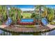 Scenic view of the Heritage Harbor community sign surrounded by lush landscaping, water features and palm trees at 4207 Fishermans Lake Dr, Lutz, FL 33558