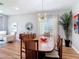 Bright dining room features wood floors, modern lighting, and space to host Gathering and friends at 4207 Fishermans Lake Dr, Lutz, FL 33558
