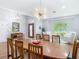 Bright dining room features wood floors, modern lighting, and space to host Gathering and friends at 4207 Fishermans Lake Dr, Lutz, FL 33558