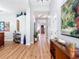 Inviting foyer featuring hardwood floors, neutral walls, and an open layout leading to a staircase and living spaces at 4207 Fishermans Lake Dr, Lutz, FL 33558