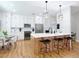 Bright, modern kitchen with white cabinets, stainless steel appliances, and stylish pendant lighting over the island at 4207 Fishermans Lake Dr, Lutz, FL 33558
