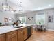 A gourmet kitchen with stainless steel appliances, a large island, and an adjacent dining area at 4207 Fishermans Lake Dr, Lutz, FL 33558