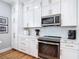 Beautiful kitchen with white cabinetry, stainless steel appliances, and complementary backsplash at 4207 Fishermans Lake Dr, Lutz, FL 33558