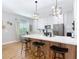 Bright kitchen with white cabinets, stainless steel appliances, and an island with bar seating at 4207 Fishermans Lake Dr, Lutz, FL 33558