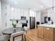 Open kitchen with white cabinets, stainless appliances, and adjacent dining area at 4207 Fishermans Lake Dr, Lutz, FL 33558