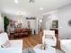 Open-concept living room features wood floors that flow into the dining room at 4207 Fishermans Lake Dr, Lutz, FL 33558