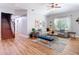Open-concept living room featuring hardwood floors, modern furniture, and a staircase at 4207 Fishermans Lake Dr, Lutz, FL 33558