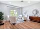 Living room features wood floors and lots of natural light from the large windows at 4207 Fishermans Lake Dr, Lutz, FL 33558