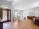 Open-concept living room features wood floors and lots of natural light from the large windows and doors at 4207 Fishermans Lake Dr, Lutz, FL 33558