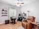 Office space features a ceiling fan, shelving, desk, and comfortable leather chair at 4207 Fishermans Lake Dr, Lutz, FL 33558