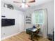 An office space featuring a ceiling fan, modern desk, and decorative wall art at 4207 Fishermans Lake Dr, Lutz, FL 33558