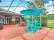Scenic screened-in patio featuring blue chairs and beautiful views at 4207 Fishermans Lake Dr, Lutz, FL 33558