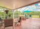 Spacious screened-in patio featuring ample seating, perfect for outdoor entertaining at 4207 Fishermans Lake Dr, Lutz, FL 33558