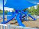 Colorful playground with slides and climbing structures, covered by a blue shade at 4207 Fishermans Lake Dr, Lutz, FL 33558
