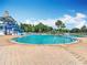 Community pool featuring a slide and ample seating on a sunny day at 4207 Fishermans Lake Dr, Lutz, FL 33558