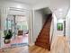 Hallway with wood staircase leading to the second floor and sliding glass doors to the patio at 4207 Fishermans Lake Dr, Lutz, FL 33558