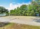 Outdoor sand volleyball court surrounded by green foliage in a residential community at 4207 Fishermans Lake Dr, Lutz, FL 33558