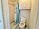 Cozy bathroom featuring a toilet, shower with blue accents at 4333 Baden Dr, Holiday, FL 34691