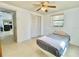 This is a bright bedroom with a single bed, ceiling fan, window, and closet at 4333 Baden Dr, Holiday, FL 34691