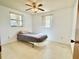 Simple bedroom with a single bed, ceiling fan, and neutral decor at 4333 Baden Dr, Holiday, FL 34691