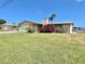 Charming single-story home with a well-maintained lawn and mature landscaping at 4333 Baden Dr, Holiday, FL 34691