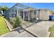 Exterior view of a screened patio with a well-maintained backyard and greenery at 4333 Baden Dr, Holiday, FL 34691