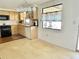 Cozy eat-in kitchen features wood cabinets and black appliances under modern lighting at 4333 Baden Dr, Holiday, FL 34691