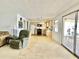 Open-concept living area leading to the kitchen, bathed in natural light from sliding glass doors at 4333 Baden Dr, Holiday, FL 34691