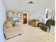 Cozy living room featuring neutral-toned couches, a unique stone-accented wall, and a view of the front door at 4333 Baden Dr, Holiday, FL 34691