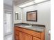 Bathroom with single sink vanity, granite countertop, and contemporary mirror at 4369 Marine Pkwy, New Port Richey, FL 34652