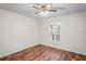 Bright bedroom with wood floors, ceiling fan, and shuttered window at 4369 Marine Pkwy, New Port Richey, FL 34652