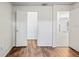 Bedroom showcasing wood floors, closet, and view to an adjoining living space at 4369 Marine Pkwy, New Port Richey, FL 34652