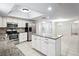 Bright kitchen with white cabinets, granite countertops, stainless appliances, and large island at 4369 Marine Pkwy, New Port Richey, FL 34652