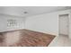 Spacious living room featuring wood-look floors, plantation shutters, and neutral paint at 4369 Marine Pkwy, New Port Richey, FL 34652