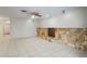 Bright living room featuring a stone fireplace and white tile floors, perfect for cozy evenings at 4369 Marine Pkwy, New Port Richey, FL 34652