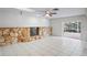 Spacious living room featuring stone fireplace and access to a screened patio at 4369 Marine Pkwy, New Port Richey, FL 34652