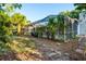 A screened in pool is the focal point of the landscaped backyard at 4369 Marine Pkwy, New Port Richey, FL 34652